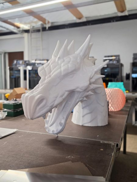 Detailed white dragon sculpture in a workshop